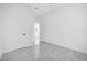 Bedroom with white walls, marble flooring, and a view of an adjacent room at 600 Lakewood Ave, Ocoee, FL 34761