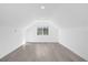Bonus room with a window for natural light, recessed lights, and sleek wood flooring at 600 Lakewood Ave, Ocoee, FL 34761