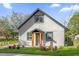 Charming home featuring a neutral paint, framed windows, and lush landscaping at 600 Lakewood Ave, Ocoee, FL 34761