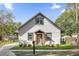 Charming home featuring a neutral paint, framed windows, and lush landscaping at 600 Lakewood Ave, Ocoee, FL 34761