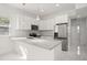 Modern kitchen with white cabinets, stainless steel appliances, gray countertops, and marble floors at 600 Lakewood Ave, Ocoee, FL 34761