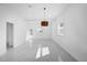 Bright living room features white marble floors, recessed lighting, and modern light fixture at 600 Lakewood Ave, Ocoee, FL 34761