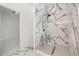 Modern shower featuring marble wall tiling, pebble floor tiling and a rainfall showerhead at 600 Lakewood Ave, Ocoee, FL 34761