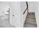 View of staircase and hall from kitchen with white walls and marble flooring at 600 Lakewood Ave, Ocoee, FL 34761