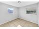 Bright bedroom featuring neutral paint, tile flooring, and windows for ample natural light at 619 Carver Dr, Lake Wales, FL 33853