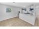 Bright kitchen featuring blue cabinets, a modern faucet and a breakfast bar at 619 Carver Dr, Lake Wales, FL 33853