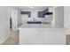 Charming kitchen featuring blue cabinets, a modern faucet and a breakfast bar at 619 Carver Dr, Lake Wales, FL 33853