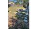 Spacious backyard with a fire pit, wooden fence, and stepping stone walkway at 636 S Wellington Dr, Deltona, FL 32725