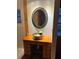 Stylish bathroom featuring a vessel sink with floral motif and an ornate, decorative mirror at 636 S Wellington Dr, Deltona, FL 32725