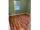 Bedroom featuring wood-look floors, green walls, and a bright window at 636 S Wellington Dr, Deltona, FL 32725