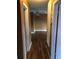 Hallway with wood floors leading to the living room with a ceiling fan at 636 S Wellington Dr, Deltona, FL 32725