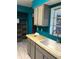Kitchen featuring updated gray cabinets, wood countertop, and tile floors at 636 S Wellington Dr, Deltona, FL 32725