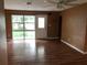 Living room with wood floors, a ceiling fan, and a large window at 636 S Wellington Dr, Deltona, FL 32725