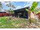 Backyard featuring a covered lanai and lush greenery, perfect for relaxation at 6701 Belmar Dr, Orlando, FL 32807