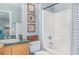 Bathroom featuring a vanity, a basket, decor, and a shower-tub combination with a blue and white striped curtain at 6701 Belmar Dr, Orlando, FL 32807