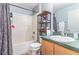 Clean bathroom featuring a tub, shower, toilet, vanity, and storage shelf at 6701 Belmar Dr, Orlando, FL 32807