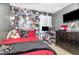 View of teen bedroom featuring dark wood furniture, bold wallpaper, and tile flooring at 6701 Belmar Dr, Orlando, FL 32807