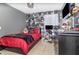 View of teen bedroom featuring dark wood furniture, bold wallpaper, and tile flooring at 6701 Belmar Dr, Orlando, FL 32807