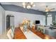 Open dining and living space with modern lighting, neutral walls, and gray accent paint at 6701 Belmar Dr, Orlando, FL 32807