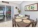 A dining room with four chairs around a wooden table, and a sliding glass door to the outside at 6701 Belmar Dr, Orlando, FL 32807