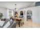 Cozy dining room adjacent to living room with a wooden dining table set for entertaining at 6701 Belmar Dr, Orlando, FL 32807