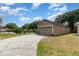 Spacious driveway leads to a two-car garage, surrounded by green lawn at 6701 Belmar Dr, Orlando, FL 32807