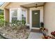 Charming home featuring a cozy front porch with a decorative olive green door at 6701 Belmar Dr, Orlando, FL 32807