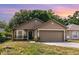 Charming single-Gathering home with a well-manicured lawn, two car garage, and bay window at 6701 Belmar Dr, Orlando, FL 32807