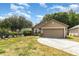 Well-maintained single-story home with a curved driveway, two-car garage, and neatly landscaped front yard at 6701 Belmar Dr, Orlando, FL 32807