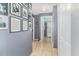 Hallway leading to bathroom with tile flooring, gray walls decorated with black and white photos at 6701 Belmar Dr, Orlando, FL 32807