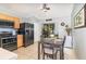 Bright eat-in kitchen with black appliances and natural wood cabinets with outdoor access to lanai at 6701 Belmar Dr, Orlando, FL 32807