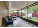 Enclosed lanai offering a view of the backyard and comfortable seating at 6701 Belmar Dr, Orlando, FL 32807
