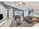 Bright living room with comfortable gray sofas, neutral walls and ceiling fan at 6701 Belmar Dr, Orlando, FL 32807