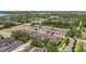 An aerial view shows the townhomes and surrounding landscape, including a pond and lush greenery at 7010 Broomshedge Trl, Winter Garden, FL 34787