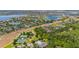 Aerial shot featuring a neighborhood with lakes, community amenities, including a pool, tennis and basketball courts at 7010 Broomshedge Trl, Winter Garden, FL 34787