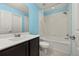 Bathroom with blue walls, white tile, shower/tub combination at 7010 Broomshedge Trl, Winter Garden, FL 34787