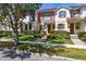 Inviting townhome featuring manicured landscaping and a covered front entry for a welcoming appeal at 7010 Broomshedge Trl, Winter Garden, FL 34787
