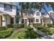 Charming two-story townhome with well-manicured lawn and shrubbery in a desirable community at 7010 Broomshedge Trl, Winter Garden, FL 34787