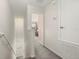 Well-lit hallway with carpeted floors leads to bedroom at 7010 Broomshedge Trl, Winter Garden, FL 34787