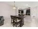 Charming dining area and kitchen featuring granite countertops, dark wood cabinets, and modern appliances at 7010 Broomshedge Trl, Winter Garden, FL 34787