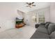 Comfortable living room with tile flooring, a stylish gray couch, and plenty of natural light at 7010 Broomshedge Trl, Winter Garden, FL 34787