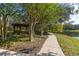 A scenic walking path meanders past a charming gazebo by the lake at 7010 Broomshedge Trl, Winter Garden, FL 34787