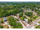 Aerial view shows the property with red boundary lines, surrounded by lush greenery and neighboring homes at 7506 Mott Ave, Orlando, FL 32810