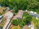 Aerial view of property with driveway and surrounding landscape and trees at 7506 Mott Ave, Orlando, FL 32810