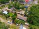 Aerial view showcases the property's location, surrounded by lush greenery and neighboring homes at 7506 Mott Ave, Orlando, FL 32810
