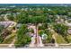 An aerial perspective shows the property next to neighboring homes with lush greenery at 7506 Mott Ave, Orlando, FL 32810