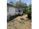 View of home's siding, landscaping, and exterior structure at 7506 Mott Ave, Orlando, FL 32810