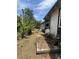 View of back of home with landscaping, weathered trim, and fencing at 7506 Mott Ave, Orlando, FL 32810