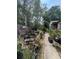 Picture of a backyard setting with diverse plants, a grill, and outdoor furniture at 7506 Mott Ave, Orlando, FL 32810
