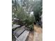 Backyard showcasing an outdoor bench, trees, and space for gardening or leisure activities at 7506 Mott Ave, Orlando, FL 32810